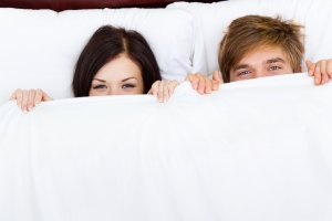couple under bed covers